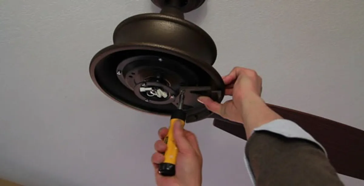 Electrician installing ceiling fan mounting bracket and fixture in Redding, CA