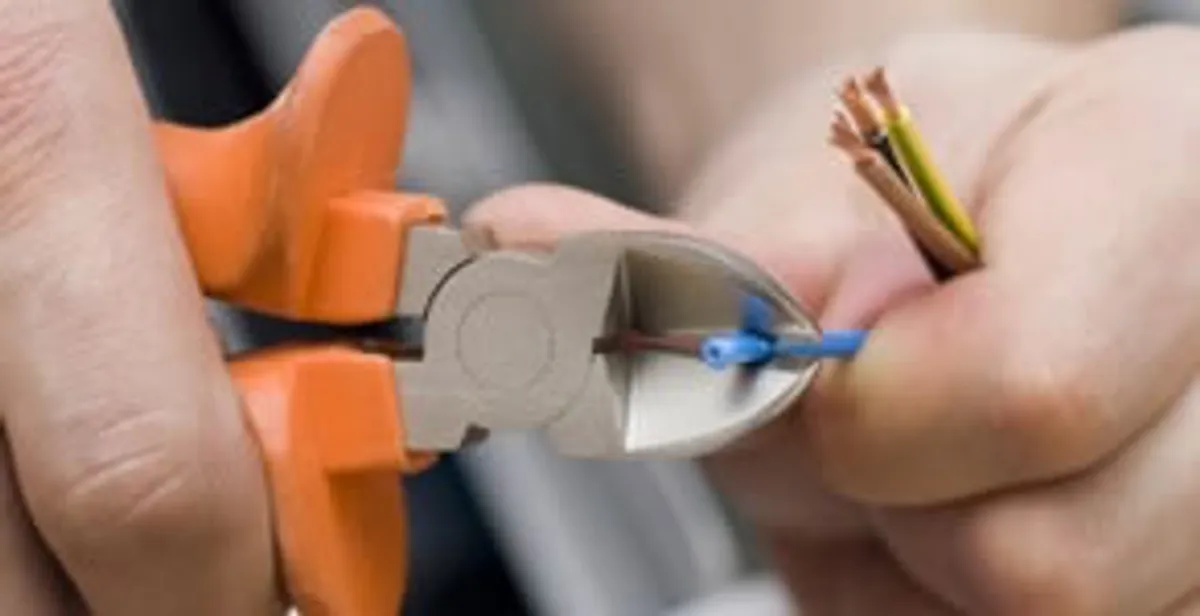 professional electrical services showing precise wire cutting by licensed electricians in Redding, CA